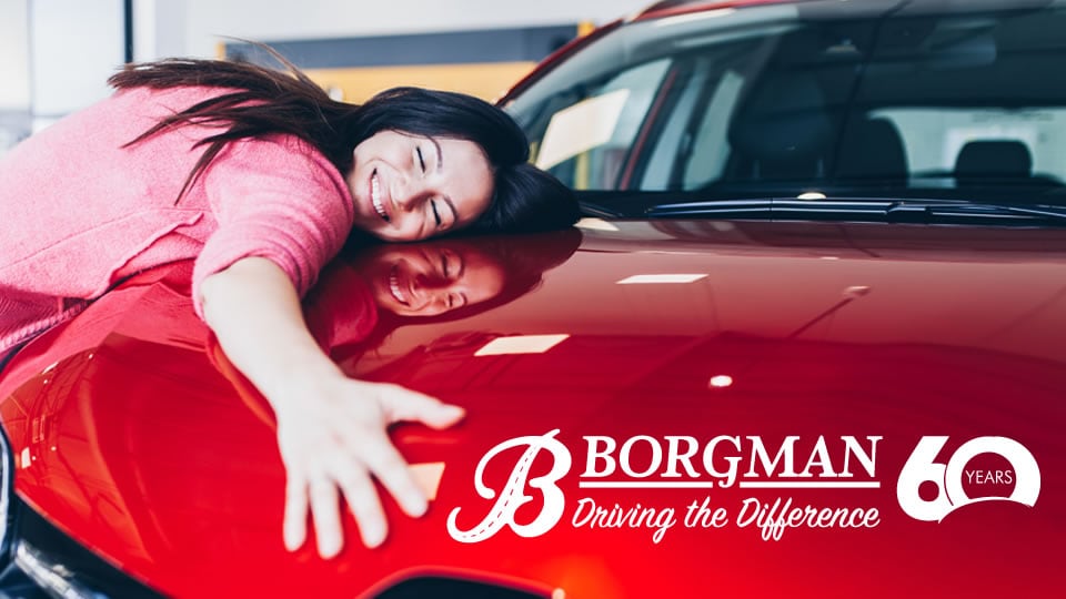 woman laying on car Borgman Mazda in Grandville MI